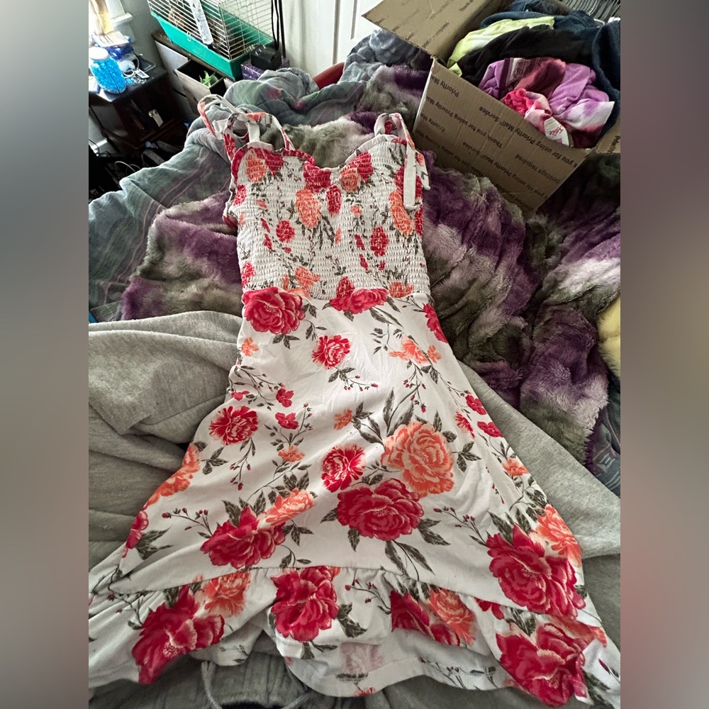 A white dress with red-ish/pink flowers all throughout